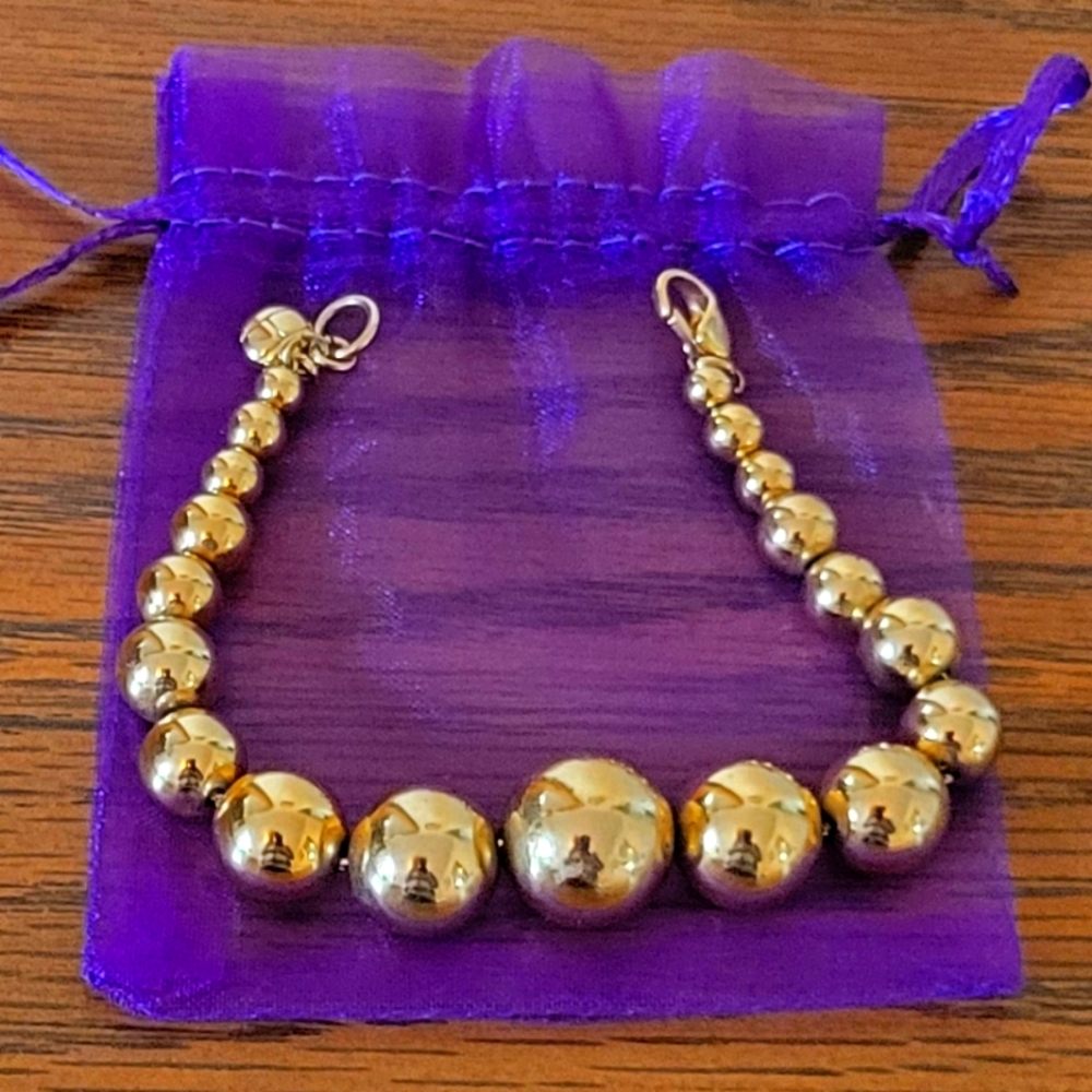 Graduating small to large mm gold balls hardware stamped vintage bracelet.